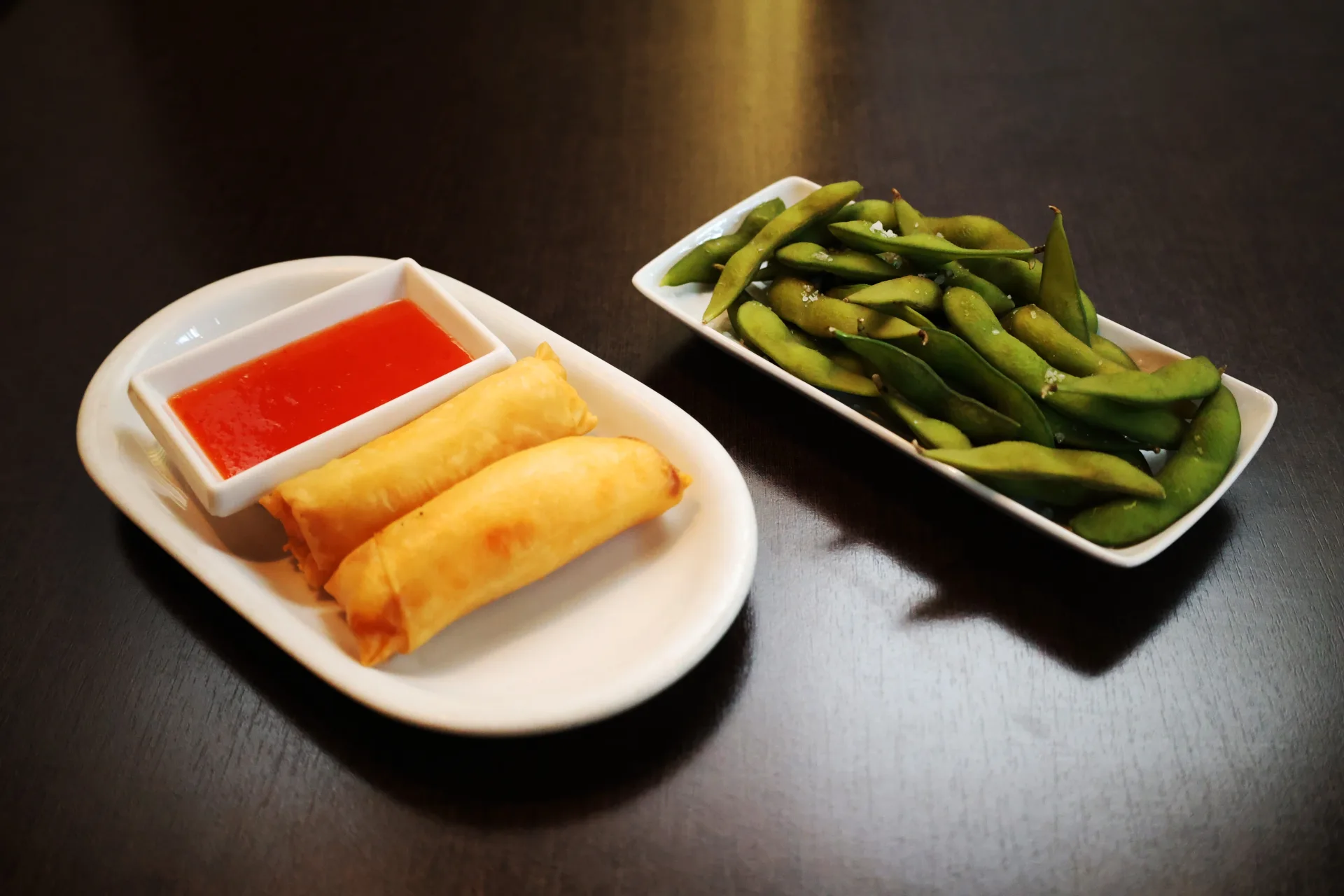 Crisp spring rolls and salted edamame at Koko