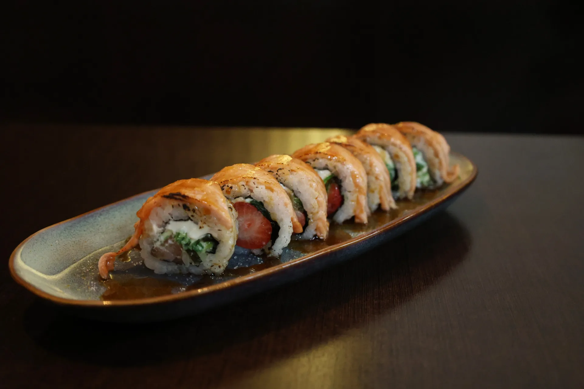 Signature salmon sushi roll plated at Koko